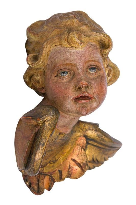 Carved and painted wood face of angel 