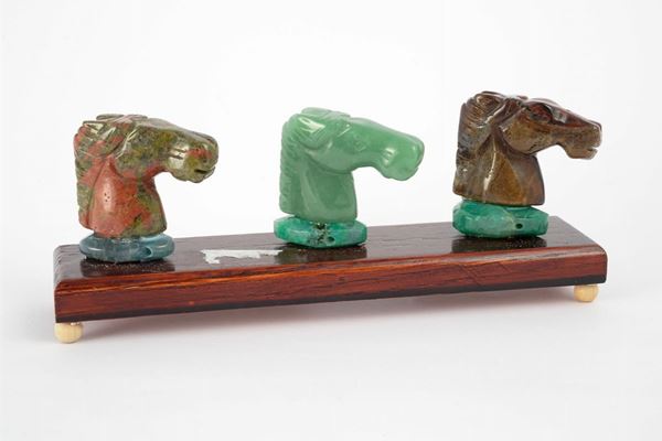 Group of three sculptures depicting horse heads